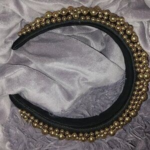 Gold and black headband with gold balls on it